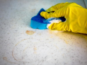 cleaning countertop hands with gloves